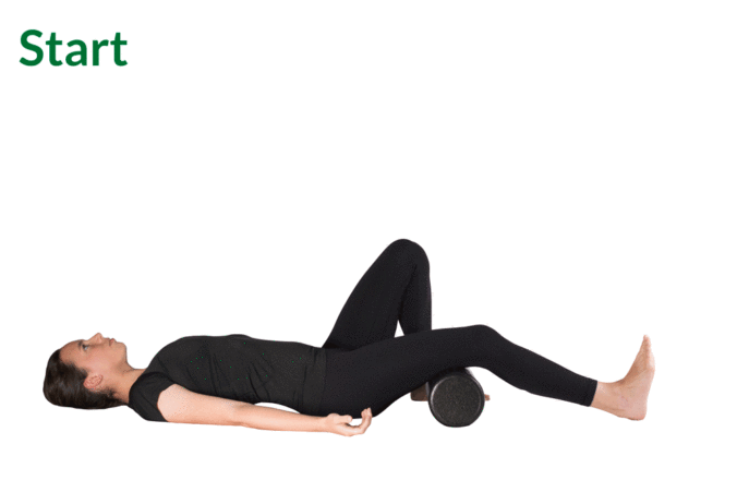 Woman lying supine with right leg straight and resting on a foam roller. Animation shows low back pressing into ground, left bent leg flexing up, and finally left knee extending straight above body