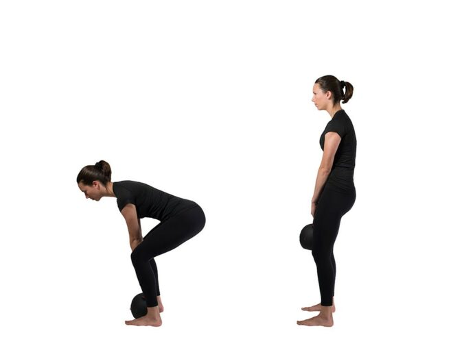 First image shows a woman bent over with a straight back, grabbing a kettlebell that's resting on the ground with both hands. Second image shows the woman standing up straight, still holding the kettlebell.