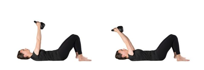Woman lying supine with kettlebell in hands, arms straight up perpendicular to the ground. Second photo shows same woman with the kettlebell hover over her head, arms still straight but now angled back toward her head.